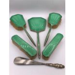 A Ladies Dressing table set in hallmarked silver with green enamel back.