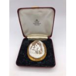 A Large Cameo in gold with a classical scene (7cm x 5.5cm)