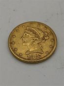 An 1887 United States of America Five Dollar coin (8.4g)