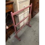 A pink painted vintage clothes rail