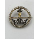 A 14ct gold and silver stone set brooch. Consisting of a yellow gold circular open brooch with a