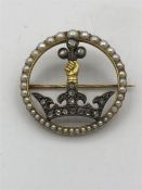 A 14ct gold and silver stone set brooch. Consisting of a yellow gold circular open brooch with a