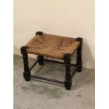 A small oak stool with rush seat