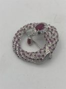 A silver brooch in the form of a snake set with rubies and CZ.