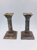 A Pair of white metal candlesticks