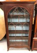 A Mahogany China Cabinet with arched glazed doors.