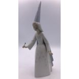 A Lladro figure of a Fairy in hat with a wand (28cm)
