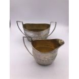 A hallmarked silver milk jug and sugar bowl (363g) by Carrington & Co London 1900-01.