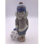 A Lladro Figure 'Eskimo Boy with pet'