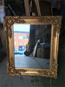 An ornate gold framed mirror 80 cm x 69cm.