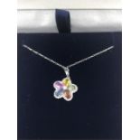 An 18ct white gold necklace with diamond flower pendant set with pink and blue Topaz citrine and
