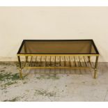 A brass long coffee table with shelf under, reeded legs and a smoked glass top.
