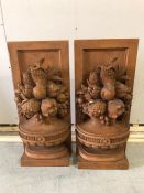 Two wood sconces with a fruit design