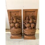 Two wood sconces with a fruit design