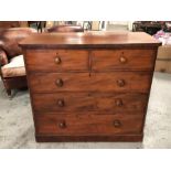 A two over three chest of drawers with bun handles.