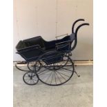 A Victorian Pram with blue wood carriage .