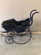 A Victorian Pram with blue wood carriage .