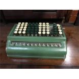 A vintage green adding machine