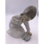 A Lladro figure Girl with a mothers shoe (13cm)