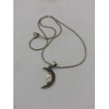 A silver pendant necklace in the form of a half moon set with Marcasite's
