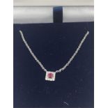 An 18ct gold ruby and diamond pendant necklace 40pts.