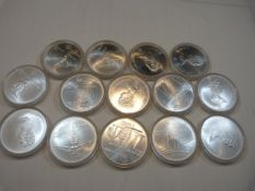 Fourteen assorted (UNC) Five dollar silver Olympic themed proof coins, cased. 1973-1976.