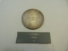 A Chinese One dollar coin in silver, dated 1914 26.4g (F)