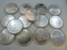 Fourteen ten dollar silver proof coins, in individual cases (48.6g each) Canadian with a sports