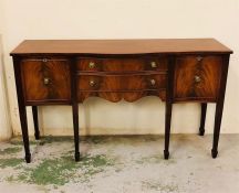 A mahogany sideboard with two central drawers and two side cupboards with brass ring handles.