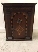 A Corner Cabinet with inlay and central round glass window.