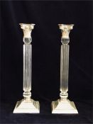 A pair of large white metal with Perspex reeded stem candlesticks.