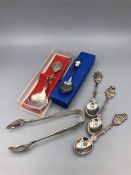 A selection of silver spoons and a set of sugar nips