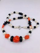 A Necklace of Coral, Onyx and Fresh Water Pearls