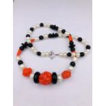 A Necklace of Coral, Onyx and Fresh Water Pearls