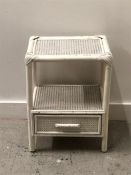 A white rattan bedside cabinet