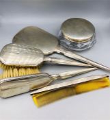A Birks Canada dressing table set to include two brushes, a comb, mirror and silver topped glass