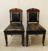 A Pair of Green leather seated carved chairs.