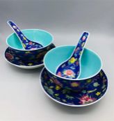 A set of Chinese bowls, saucers and spoons.