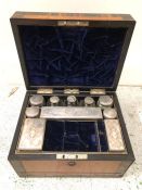 A 19th Century Ladies Travelling Vanity Case, with a number of white metal topped glass bottles