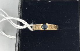 A 9ct Yellow gold and blue sapphire ring