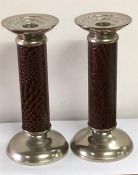 A Pair of large white metal and crocodile style leather stemmed candlesticks.