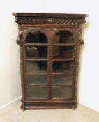 A Large carved corner cabinet with five shelves.