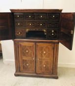 An 18th Century Rosewood two part cabinet inlaid with ivory, the top half is filled with drawers and