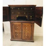 An 18th Century Rosewood two part cabinet inlaid with ivory, the top half is filled with drawers and