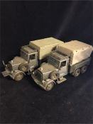A Pair of Hasbro 2007 Raiders of the Lost Arc German trucks with assorted items.