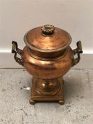 A Copper two handled urn.