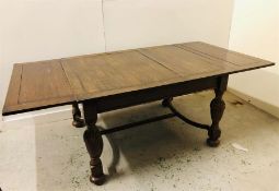 A Carved Oak dining table with detachable leaves.