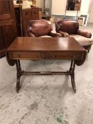 A drop leaf sofa table, Regency style with brass castors with two drawers.