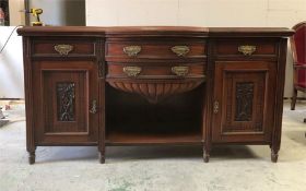 A sideboard in mahogany with bow front.