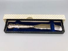 A cased hallmarked silver butter spreader, makers mark HB.
